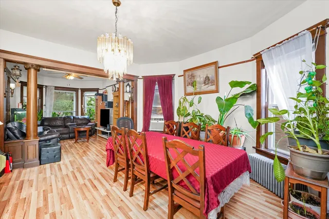 a living room filled with furniture chandelier and wooden floor