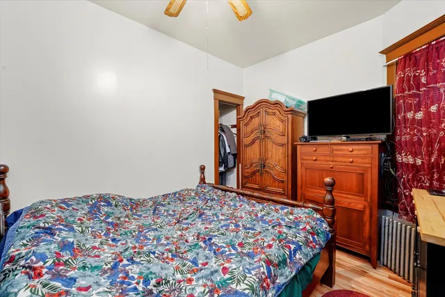 a bedroom with a bed and flat screen tv
