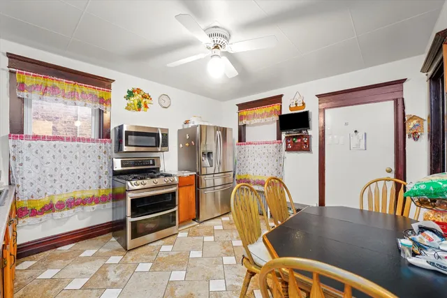 a kitchen with stainless steel appliances kitchen island granite countertop a sink refrigerator and microwave