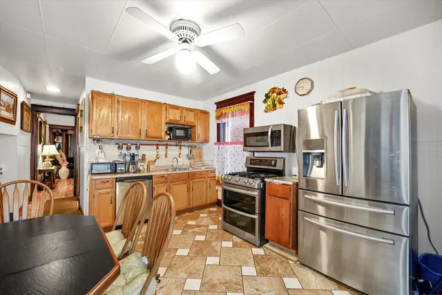 a kitchen with stainless steel appliances granite countertop a refrigerator stove top oven and sink