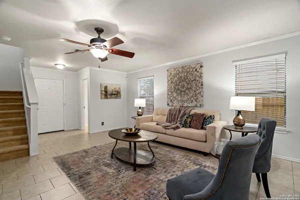 a living room with furniture a window and a chandelier