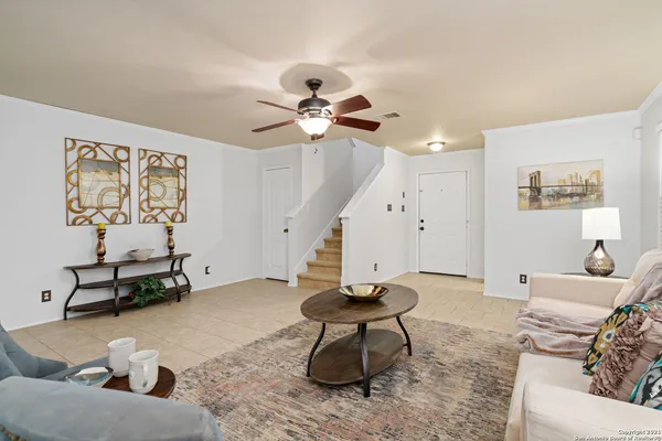 a living room with furniture and a chandelier