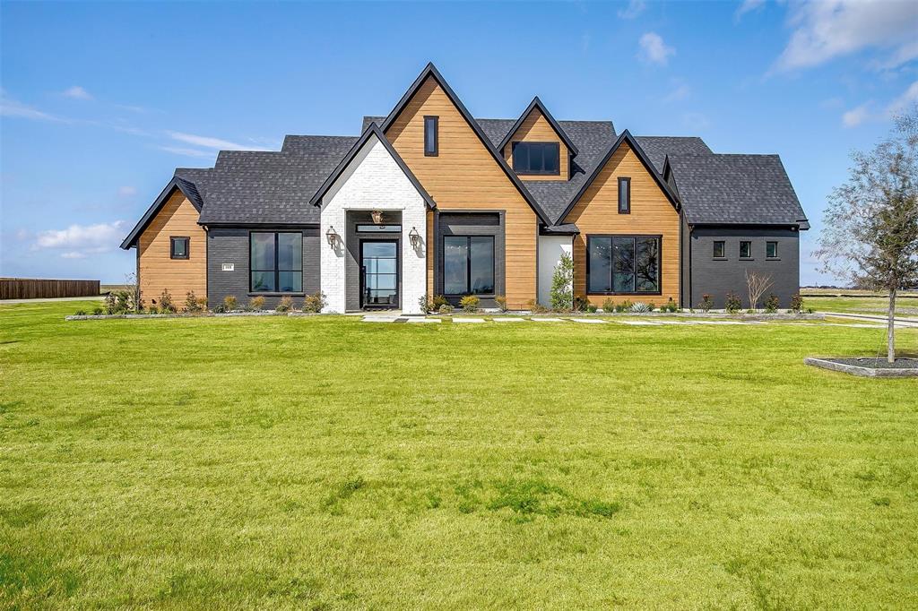 a front view of a house with yard and porch