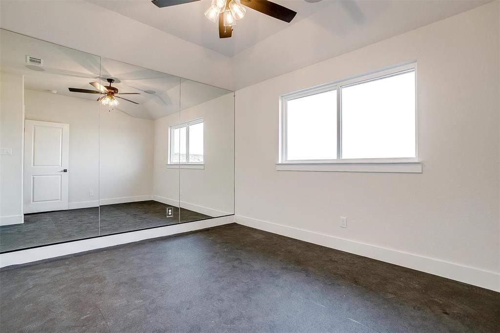 188 Ozro Road Venus, TX 76084 - Photo 21 of 32 an empty room with chandelier fan and windows