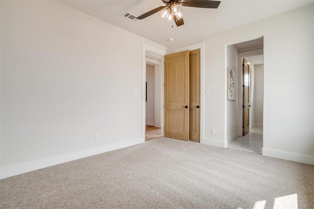 188 Ozro Road Venus, TX 76084 - Photo 25 of 32 an empty room with a chandelier fan and closet area