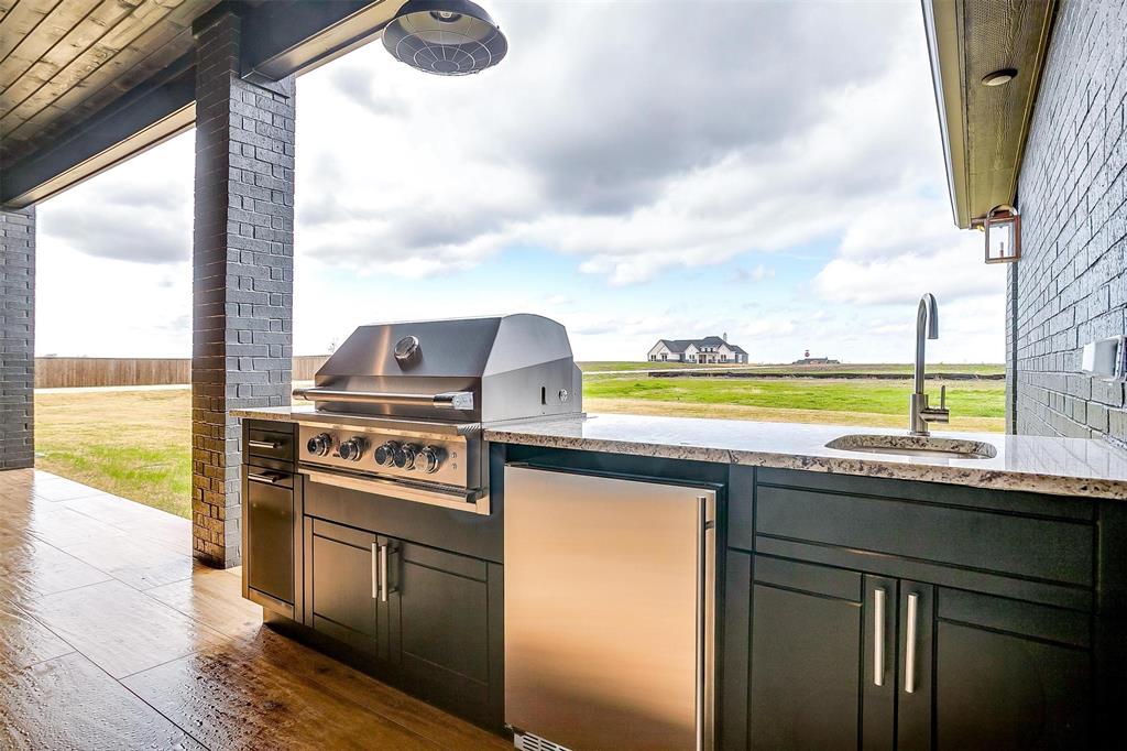 188 Ozro Road Venus, TX 76084 - Photo 31 of 32 a kitchen with a stove and a microwave