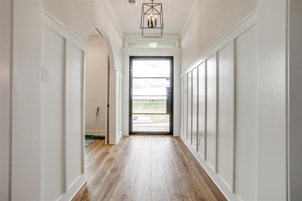 188 Ozro Road Venus, TX 76084 - Photo 4 of 32 a view of a hallway view with wooden floor and staircase