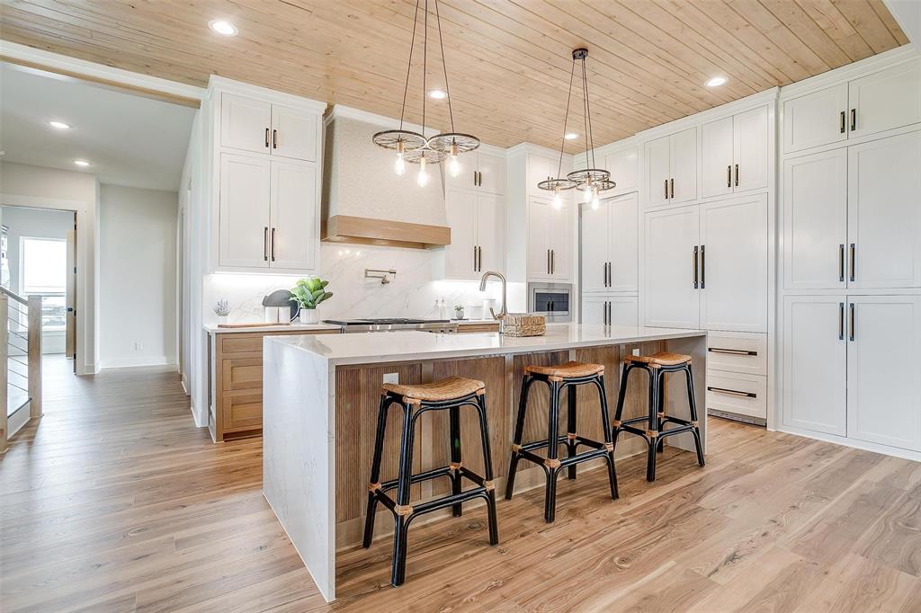 188 Ozro Road Venus, TX 76084 - Photo 10 of 32 a kitchen with granite countertop a table chairs stove a sink refrigerator and cabinets