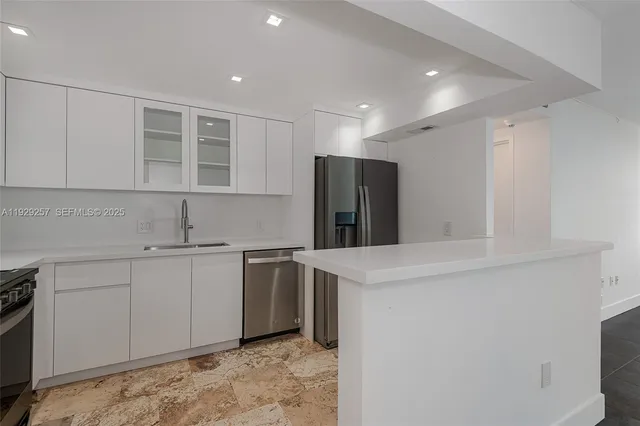 a kitchen with a sink and refrigerator