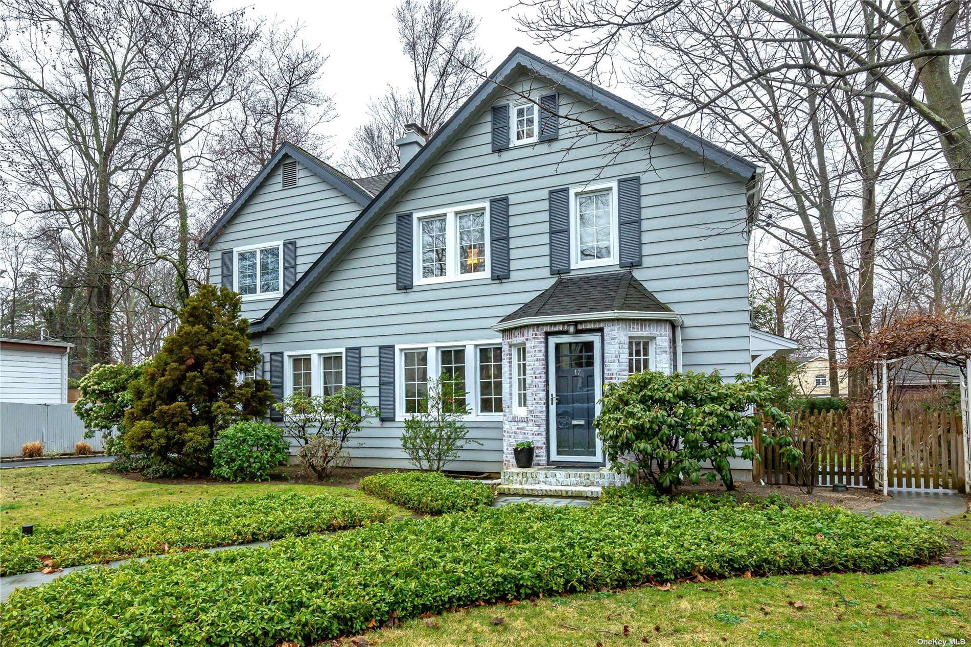 17 Johnstone Road Great Neck, NY 11021 - Photo 1 of 1 a front view of a house with a yard and potted plants