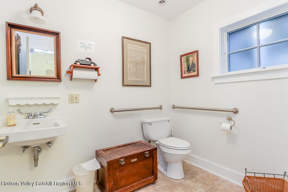 38 Main Street Chatham, NY 12037 - Photo 15 of 28 a bathroom with a toilet a sink and mirror