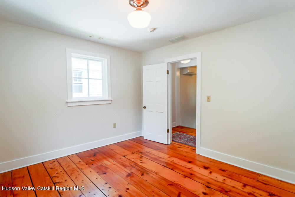 38 Main Street Chatham, NY 12037 - Photo 20 of 28 a bedroom with wooden floor and a window