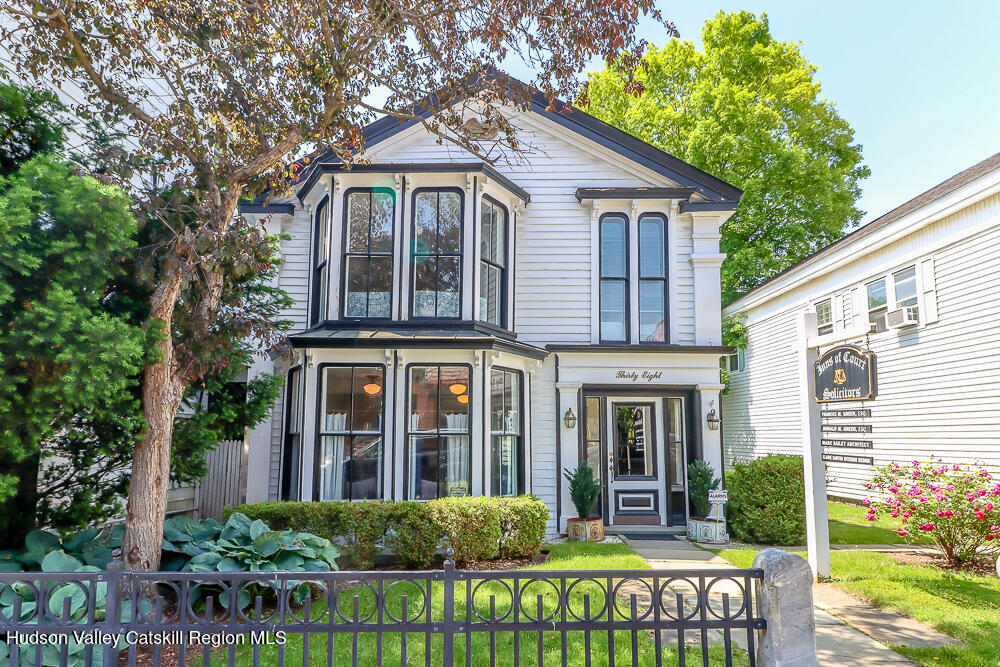 38 Main Street Chatham, NY 12037 - Photo 2 of 28 a front view of a house with a garden