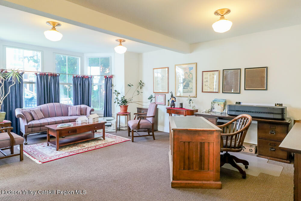 38 Main Street Chatham, NY 12037 - Photo 10 of 28 a living room with furniture gym equipment and a large window