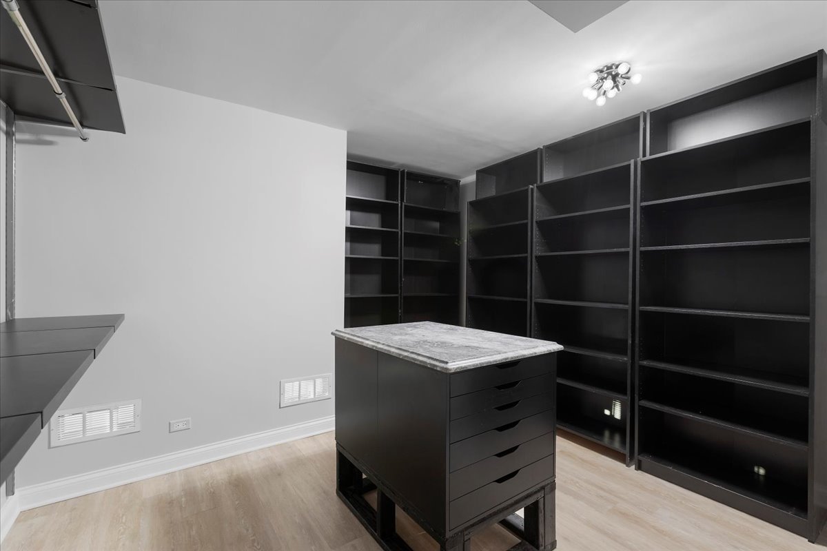 10 East Ontario Street, Unit 480102 Chicago, IL 60611 - Photo 24 of 41 a room with a furniture and a wooden floor