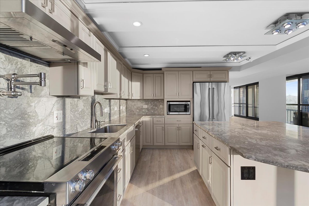 10 East Ontario Street, Unit 480102 Chicago, IL 60611 - Photo 6 of 41 a kitchen with kitchen island granite countertop a sink stainless steel appliances and counter space