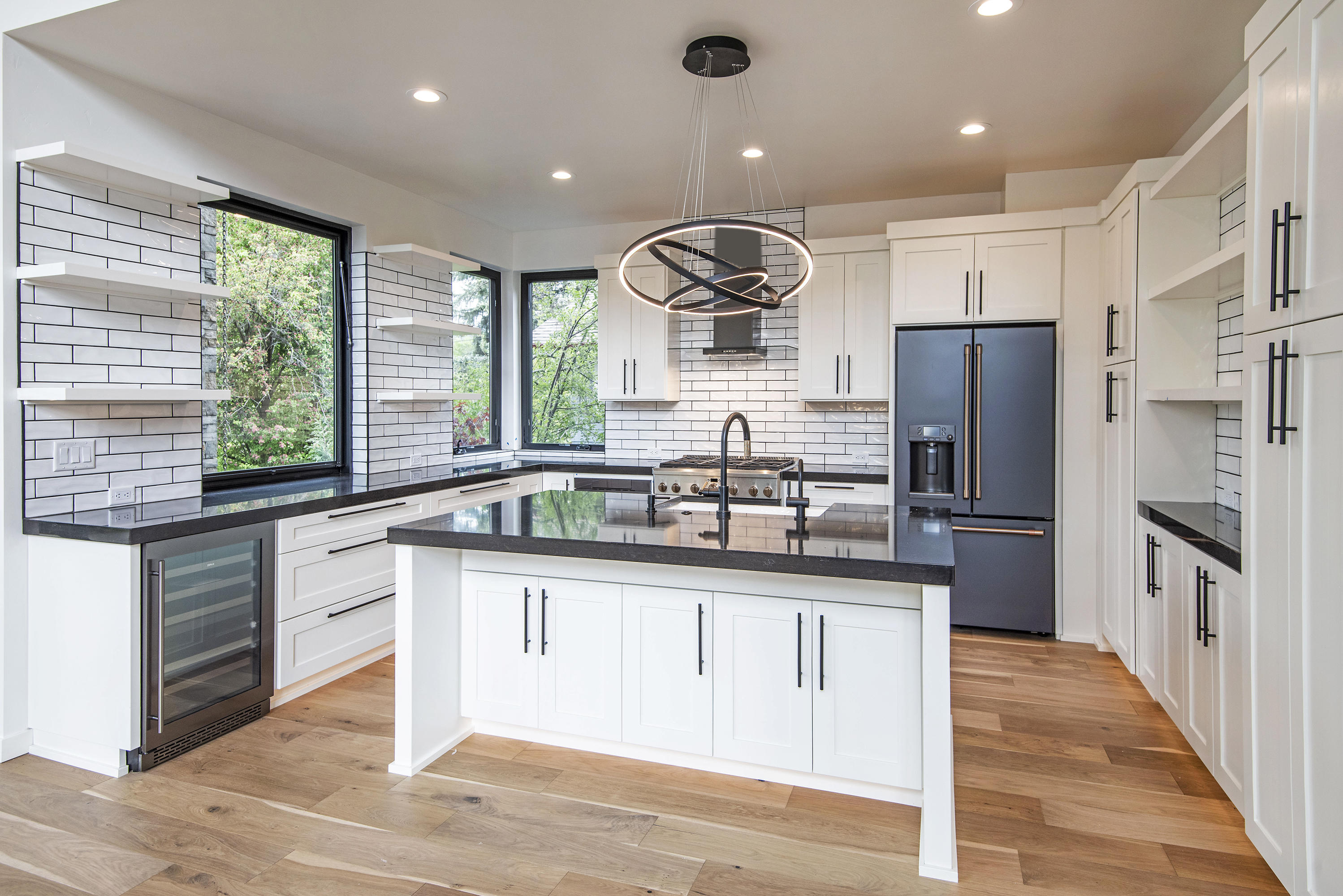 404 Northwest Riverside Boulevard Bend, OR 97703 - Photo 6 of 25 Custom-designed kitchen with great attention to detail. Awning window opens to the outdoor living area for easy access to the chef's delights.