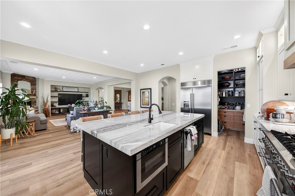 16375 Ory Circle Riverside, CA 92503 - Photo 16 of 51 a kitchen with stainless steel appliances granite countertop a kitchen island a stove and a wooden floors