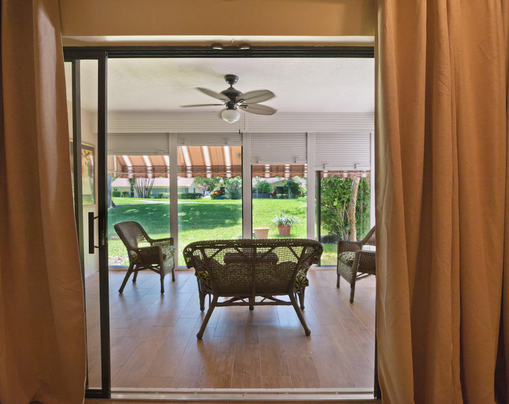 18090 104th Terrace South Boca Raton, FL 33498 - Photo 12 of 25 a dining room with furniture water view and a floor to ceiling window