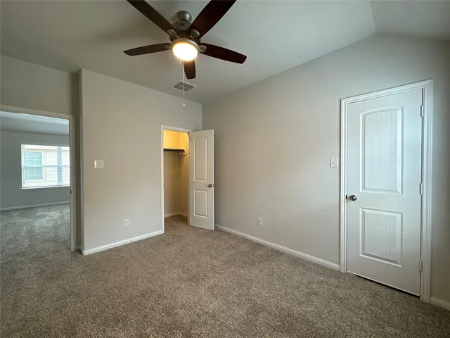 a view of an empty room and closet area