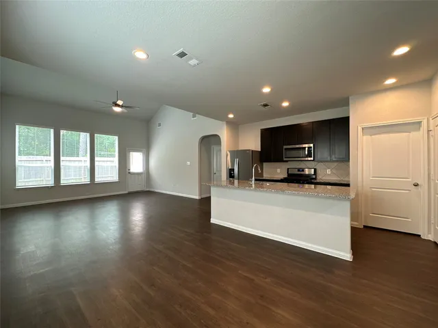 a view of kitchen with microwave and window