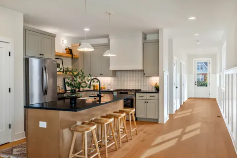 a kitchen with stainless steel appliances granite countertop a refrigerator and a stove top oven