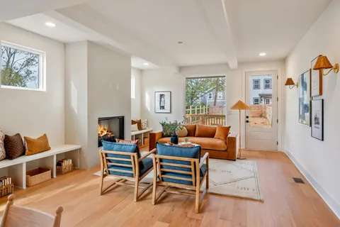a living room with furniture wooden floor and window