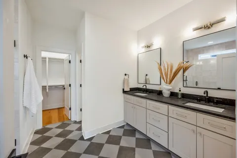 a bathroom with a double vanity sink and mirror