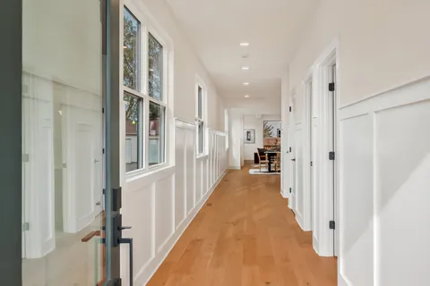 a view of a hallway with a white walls and stairs