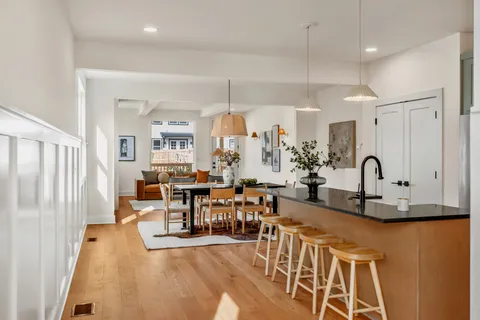 a view of a dining room with furniture and chandelier