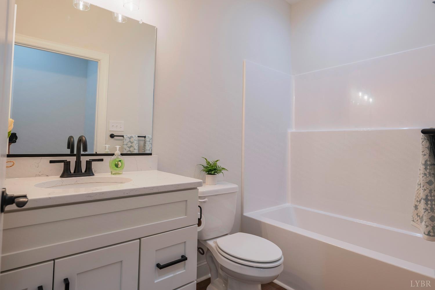 536 Leesville Road, Unit 207 Lynchburg, VA 24502 - Photo 15 of 47 a bathroom with a sink a toilet and shower