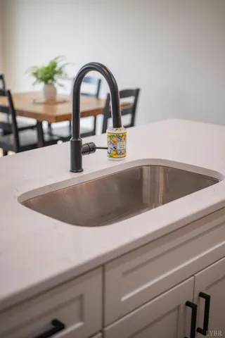 a stove top oven sitting inside of a kitchen