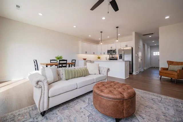 a living room with furniture and kitchen view