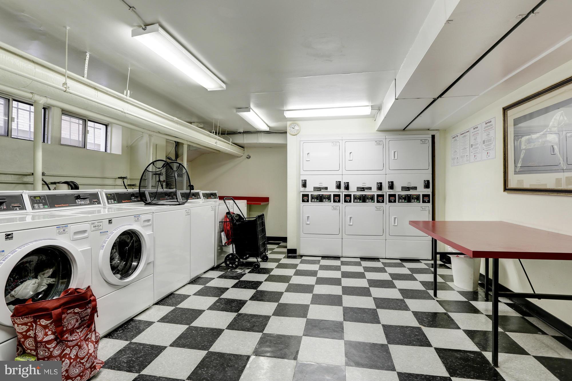 1954 Columbia Road Northwest, Unit 408 Washington, DC 20009 - Photo 12 of 12 a kitchen with a stove a sink and a washing machine
