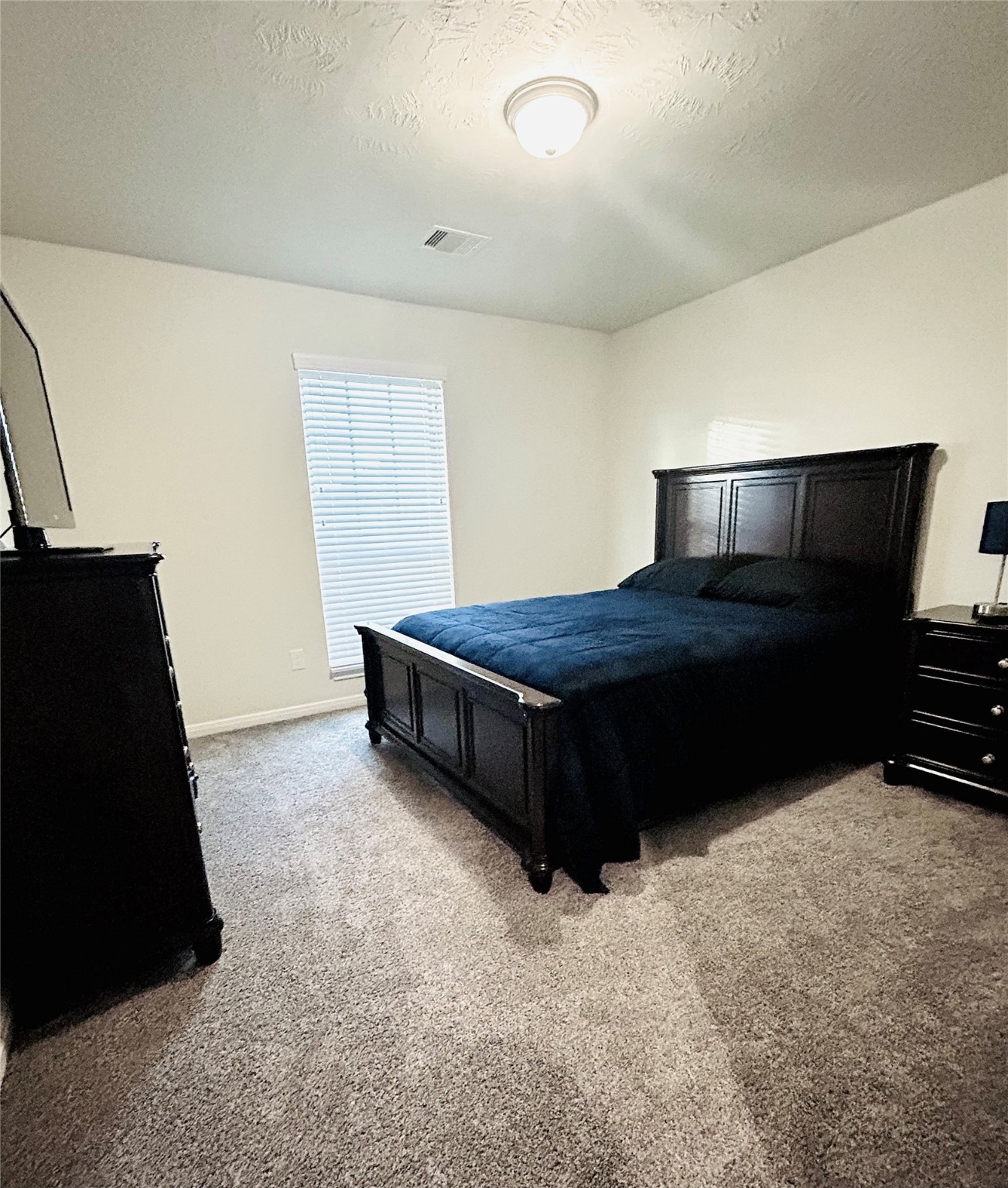 7114 Limestone Circle Manvel, TX 77578 - Photo 16 of 23 a bedroom with a bed and a night stand