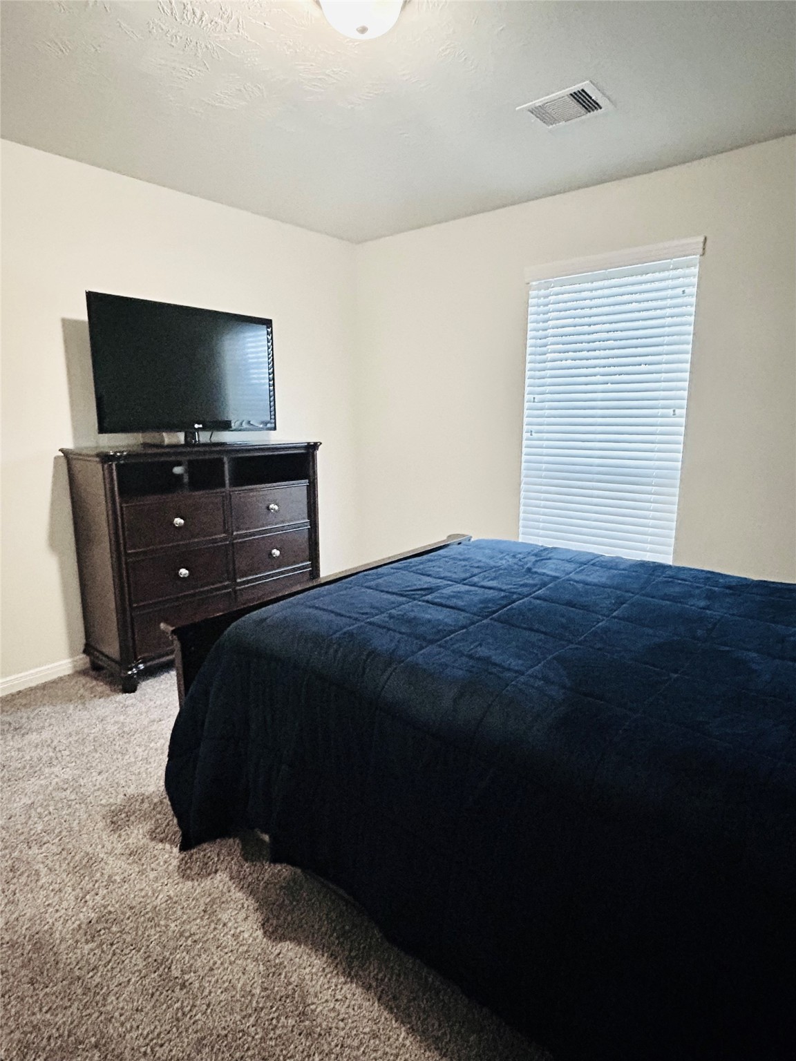 7114 Limestone Circle Manvel, TX 77578 - Photo 17 of 23 a bedroom with a bed and a flat screen tv