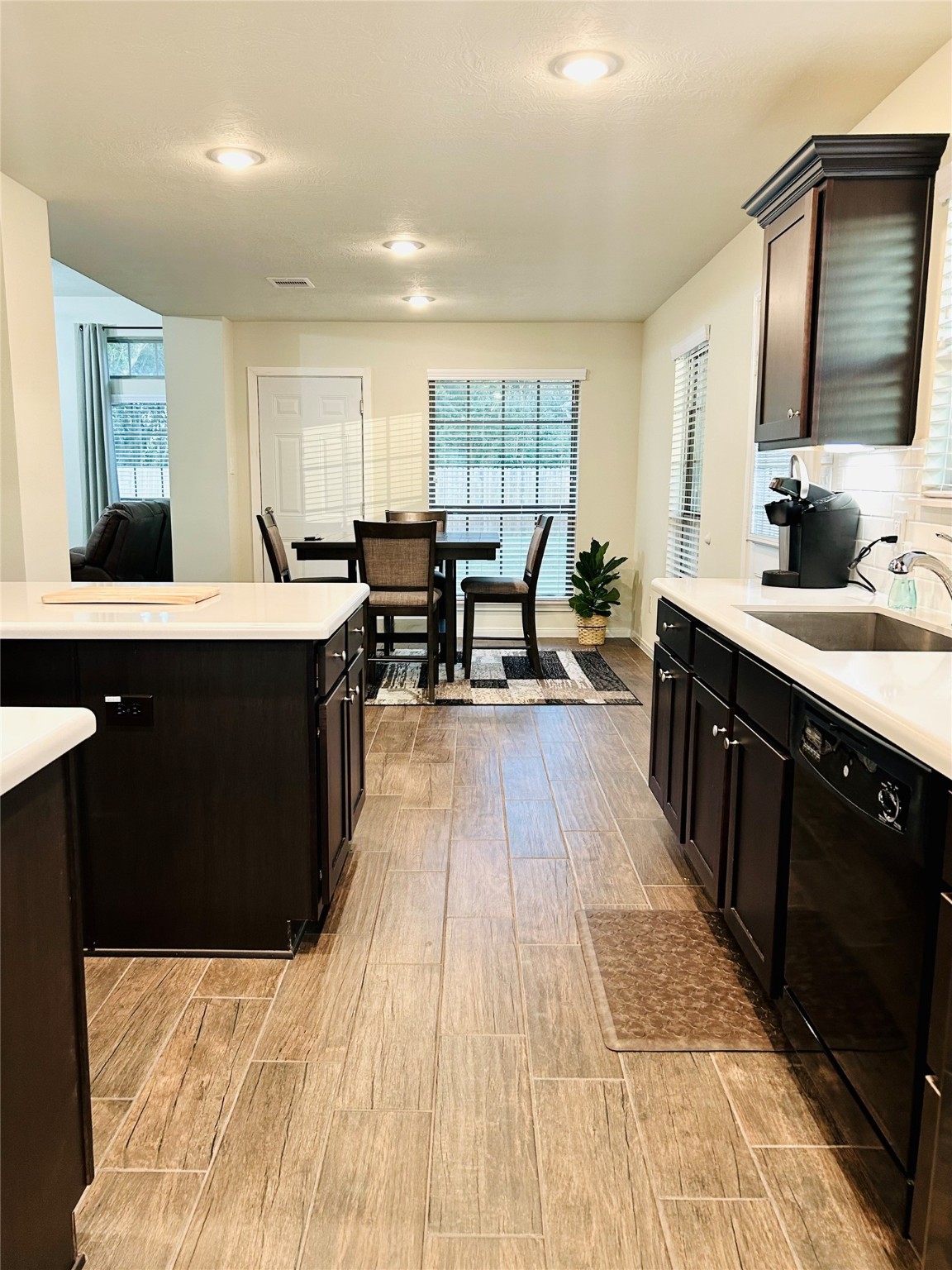 7114 Limestone Circle Manvel, TX 77578 - Photo 2 of 23 a open kitchen with stainless steel appliances kitchen island granite countertop a sink table and chairs