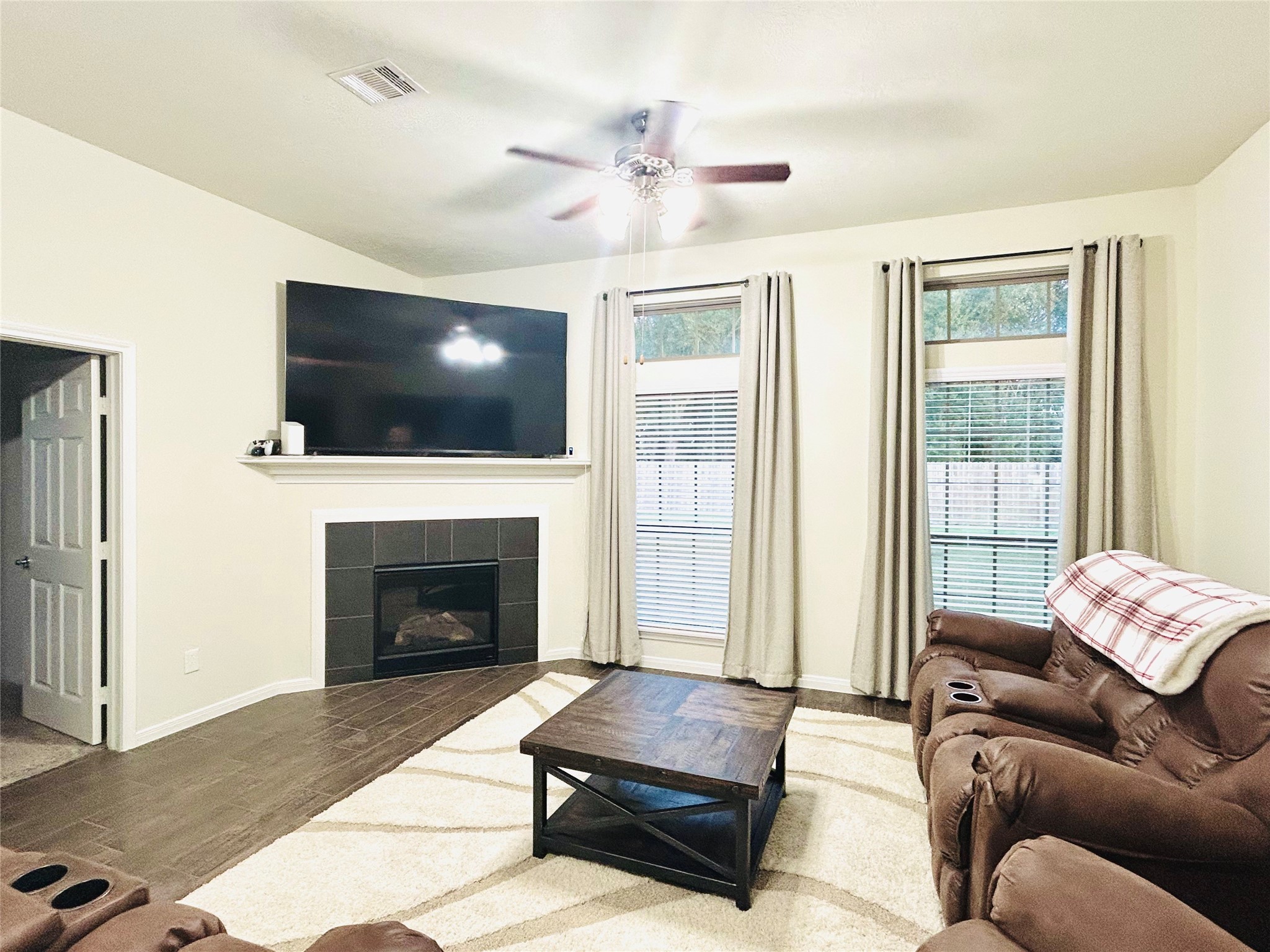 7114 Limestone Circle Manvel, TX 77578 - Photo 9 of 23 a living room with furniture a flat screen tv and a fireplace