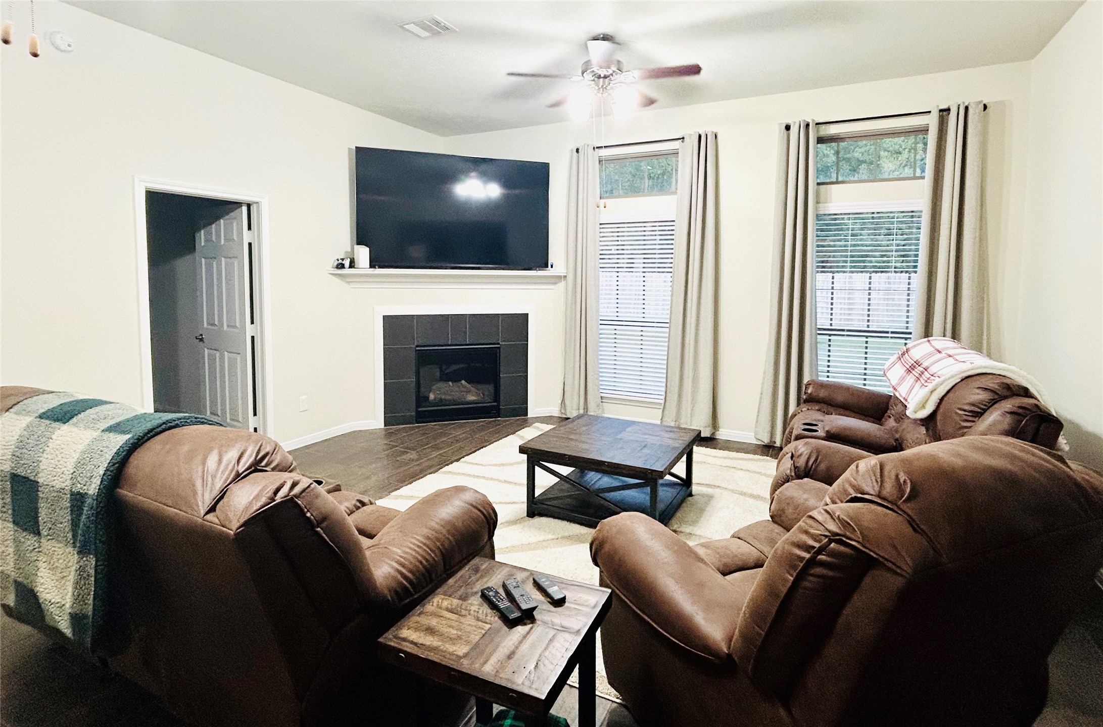 7114 Limestone Circle Manvel, TX 77578 - Photo 10 of 23 a living room with furniture a fireplace and a flat screen tv