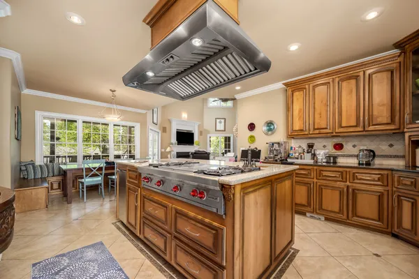 a kitchen with stainless steel appliances granite countertop sink stove and refrigerator
