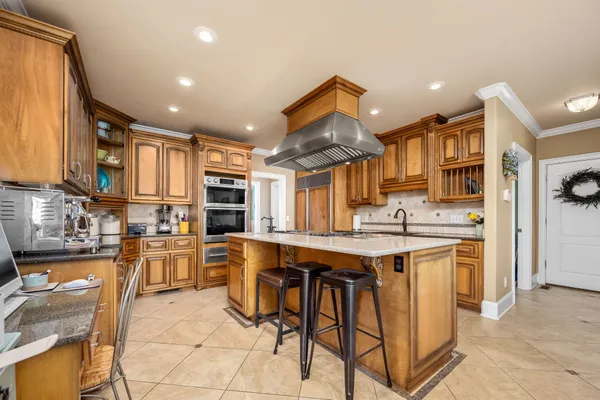 a kitchen with stainless steel appliances granite countertop a sink a stove and cabinets