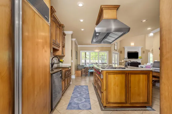 a kitchen that has a lot of cabinets in it and wooden floors
