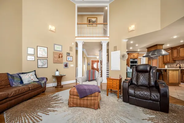 a living room with furniture and a chandelier