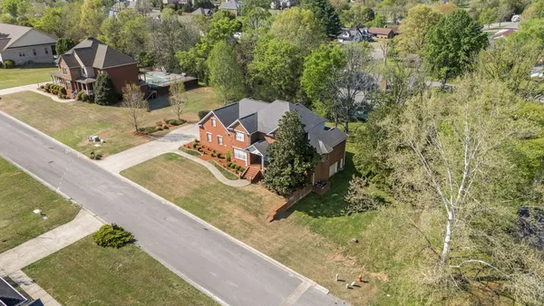 a open kitchen with stainless steel appliances granite countertop a stove top oven a sink dishwasher and white cabinets with wooden floor
