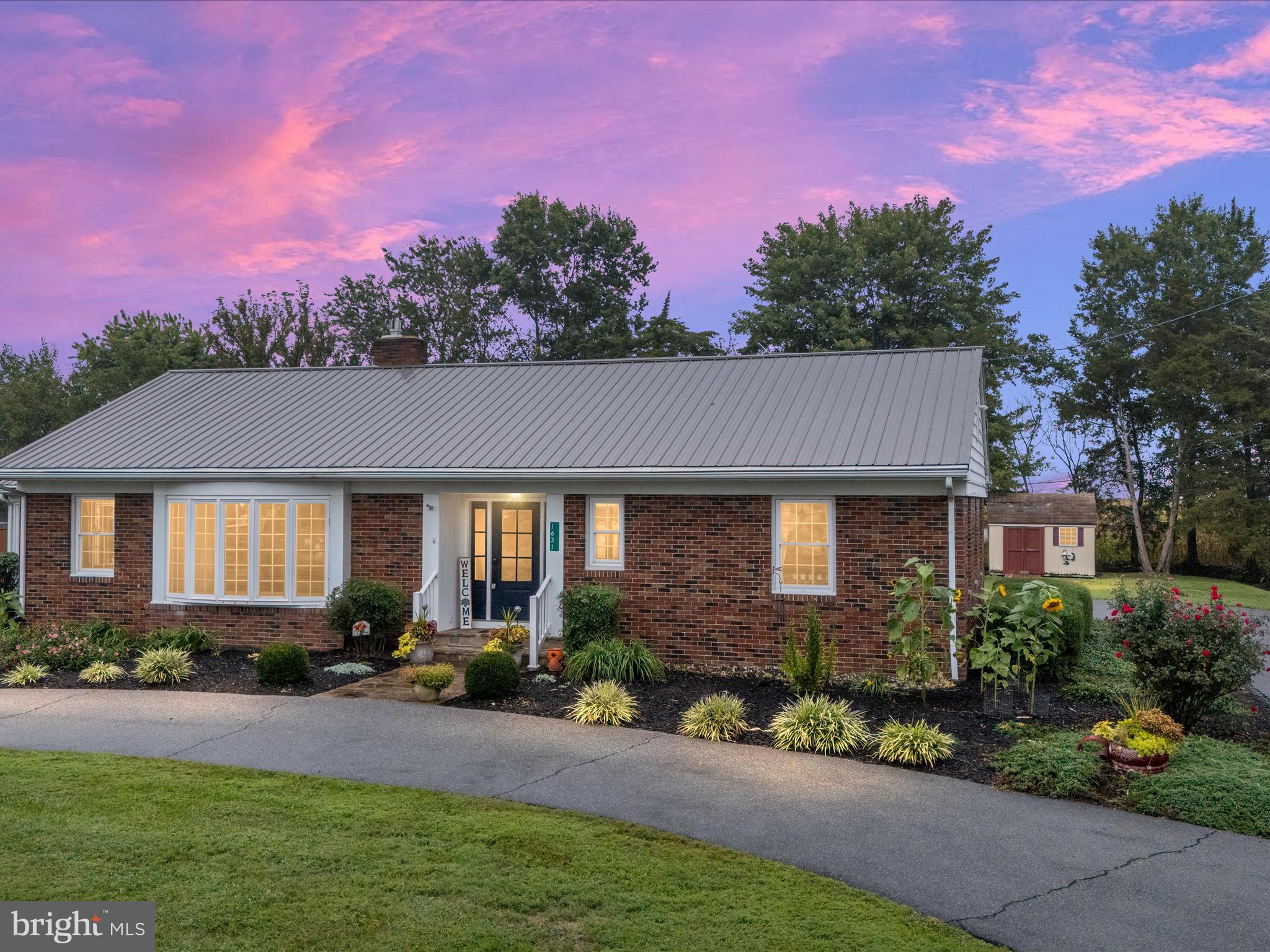 a front view of a house with a yard and outdoor seating