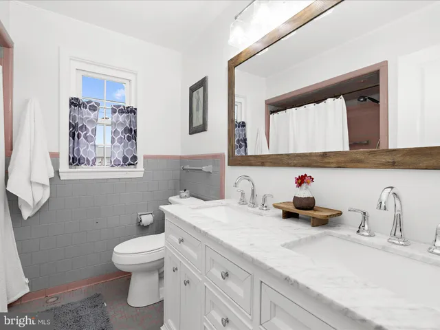 a bathroom with a toilet sink and mirror