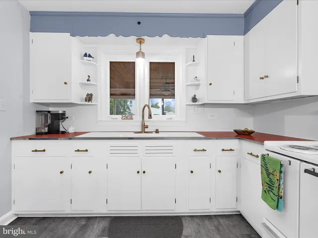a kitchen with stainless steel appliances a white cabinets and a sink