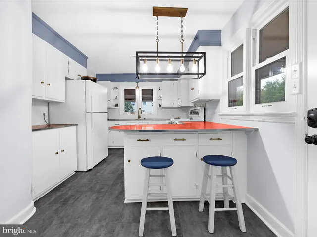 a kitchen with refrigerator and cabinets
