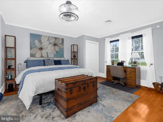 a bedroom with a bed and flat screen tv