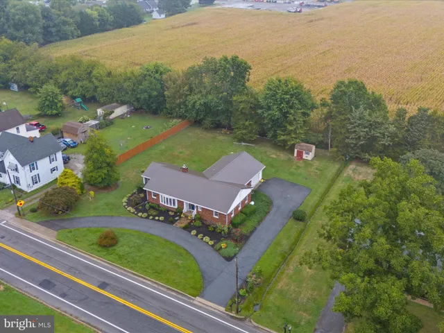 an aerial view of a house with a garden and lake view